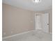 Carpeted Bedroom with tan walls and access to another room at 2712 Peachleaf St, Raleigh, NC 27614