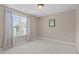 Bedroom with carpeted floor, window, curtains, and small art print at 2712 Peachleaf St, Raleigh, NC 27614