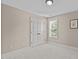 Neutral carpet bedroom with double doors, window with blinds, and overhead lighting at 2712 Peachleaf St, Raleigh, NC 27614