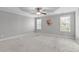 Large bedroom with carpeted floors, a ceiling fan, and multiple windows for natural light at 2712 Peachleaf St, Raleigh, NC 27614