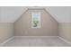 Finished upstairs bedroom with neutral walls and carpet under a window at 2712 Peachleaf St, Raleigh, NC 27614