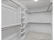 Walk-in closet features carpeted floor, shelves and rods for storage at 2712 Peachleaf St, Raleigh, NC 27614