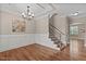 Spacious dining room with hardwood floors, wainscoting, and a staircase, offering an elegant and inviting atmosphere at 2712 Peachleaf St, Raleigh, NC 27614
