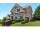 Charming two-story home featuring an attached garage and beautifully landscaped front yard with manicured shrubbery at 2712 Peachleaf St, Raleigh, NC 27614