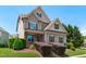 Inviting two-story home with a covered front porch, manicured landscaping, and lush green lawn at 2712 Peachleaf St, Raleigh, NC 27614