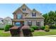 Beautiful two-story home featuring a welcoming front porch, landscaped yard, and charming architectural details at 2712 Peachleaf St, Raleigh, NC 27614