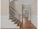 Hallway view featuring hardwood floors, wainscoting, a staircase, and arched doorway leading to another room at 2712 Peachleaf St, Raleigh, NC 27614