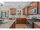 Spacious kitchen with stainless steel appliances, granite countertops, and hardwood flooring at 2712 Peachleaf St, Raleigh, NC 27614