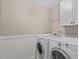 A laundry room with tile floor and washer and dryer at 2712 Peachleaf St, Raleigh, NC 27614