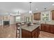 Open-concept kitchen and living room featuring hardwood floors, a fireplace, and an island with seating at 2712 Peachleaf St, Raleigh, NC 27614