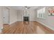 Spacious living room boasting hardwood floors, fireplace with mantel, and a large window, perfect for entertaining at 2712 Peachleaf St, Raleigh, NC 27614