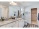 Bright bathroom with double sink vanity, granite counters, white cabinetry, and framed mirror at 272 Alice Trace Place, Angier, NC 27501
