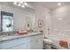 Bright bathroom featuring a double vanity, granite countertop, framed mirror, and combined tub and shower at 272 Alice Trace Place, Angier, NC 27501