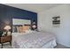 Inviting bedroom features a large window, blue accent wall, patterned bedding, and stylish decor at 272 Alice Trace Place, Angier, NC 27501