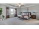 Serene bedroom with a tray ceiling, large window, and comfortable furnishings at 272 Alice Trace Place, Angier, NC 27501