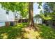 Expansive backyard featuring a white house, storage shed, and mature trees at 2725 Bedford Ave, Raleigh, NC 27607