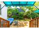 Relaxing backyard patio with bluestone, cozy blue seating, and lush greenery creating a private outdoor retreat at 2725 Bedford Ave, Raleigh, NC 27607