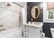 Stylish bathroom featuring marble tile, a gold-framed mirror, and modern fixtures for a luxurious touch at 2725 Bedford Ave, Raleigh, NC 27607