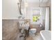 Neat bathroom showcasing tiling, a window, and elegant fixtures, combining functionality with a touch of vintage charm at 2725 Bedford Ave, Raleigh, NC 27607