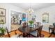 Open concept dining room with hardwood floors, chandelier and view to living room at 2725 Bedford Ave, Raleigh, NC 27607