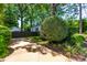 Long driveway and lush landscaping leading to the house with mature trees at 2725 Bedford Ave, Raleigh, NC 27607