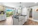 Bright kitchen features an island with farmhouse sink, black countertops, and backyard access at 2725 Bedford Ave, Raleigh, NC 27607