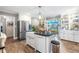 Kitchen view featuring stainless steel refrigerator, white cabinetry, black counters and backyard access at 2725 Bedford Ave, Raleigh, NC 27607