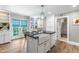 Bright kitchen features an island with farmhouse sink, black countertops, backyard access, and custom cabinetry at 2725 Bedford Ave, Raleigh, NC 27607
