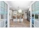 Bright kitchen with kitchen island seating and stainless steel refrigerator, as viewed from doors at 2725 Bedford Ave, Raleigh, NC 27607