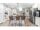 Open-concept kitchen with bar seating, stainless steel appliances, and white cabinets at 2725 Bedford Ave, Raleigh, NC 27607