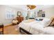 Bright main bedroom features hardwood floors, ceiling fan, and large windows with shutter blinds at 2725 Bedford Ave, Raleigh, NC 27607