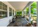Inviting screened-in porch with stone flooring, seating area, and fan for relaxing outdoors at 2725 Bedford Ave, Raleigh, NC 27607