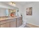 Well-lit bathroom featuring double vanity with granite countertops and a large mirror at 287 Alice Trace Place, Angier, NC 27501