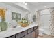 Modern bathroom with dual sinks, decorative mirror, and shower with floral curtains at 287 Alice Trace Place, Angier, NC 27501