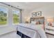 Bright bedroom with a large window, comfortable bed, and stylish decor at 287 Alice Trace Place, Angier, NC 27501