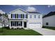 Charming two-story home featuring a classic design with black shutters, a two-car garage, and well-maintained lawn at 287 Alice Trace Place, Angier, NC 27501