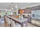 Bright kitchen featuring granite countertops, stainless steel refrigerator, and barstool seating at the island at 287 Alice Trace Place, Angier, NC 27501