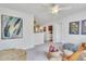 Inviting living room with neutral colors, a ceiling fan, and an open doorway to the kitchen at 287 Alice Trace Place, Angier, NC 27501