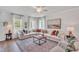 Inviting living room with a comfortable sectional sofa, decorative rug, and ample natural light at 287 Alice Trace Place, Angier, NC 27501