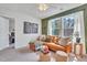 Cozy living room with a leather sofa, natural light, and green accent wall at 287 Alice Trace Place, Angier, NC 27501