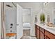 Bright bathroom boasts double sinks with dark wood cabinets, tub, and access to the bedroom at 3040 Varcroft Rd, Knightdale, NC 27545
