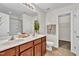 Bright bathroom features double sink vanity, decorative accents, and a separate toilet area at 3040 Varcroft Rd, Knightdale, NC 27545