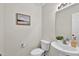 Powder room with pedestal sink, toilet, and neutral wall color, simple and elegant at 3040 Varcroft Rd, Knightdale, NC 27545