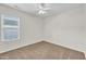 Bright bedroom with neutral walls, carpet, ceiling fan, and natural light at 3040 Varcroft Rd, Knightdale, NC 27545