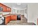 Galley kitchen with wood cabinets and granite countertops with a dark appliances at 3040 Varcroft Rd, Knightdale, NC 27545