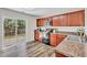 Kitchen featuring wood cabinets, granite counters, and access to the back patio at 3040 Varcroft Rd, Knightdale, NC 27545