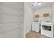Bright laundry room with shelving, washer, and dryer at 3040 Varcroft Rd, Knightdale, NC 27545