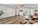 Open-concept living room with dark wood floors flowing to dining area and kitchen at 3040 Varcroft Rd, Knightdale, NC 27545