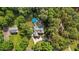Aerial view of a home showcasing its lush, wooded surroundings and in-ground pool at 308 Thomas Dr, Clayton, NC 27520