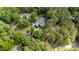 Areal view of home nestled among beautiful green trees, featuring private pool and lush landscaping at 308 Thomas Dr, Clayton, NC 27520